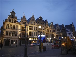 Historic buildings at night on a city square with street lamps and illuminated facades, Antwerp's
