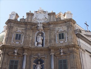 Baroque facade with statues and ornamental design on a sunny day, palermo in sicily with an