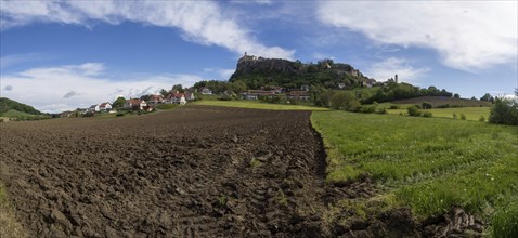 Clods of earth in farmland, Riegersburg Castle in the background, panoramic view, near Riegersburg,