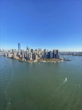 City view of an island with skyscrapers and water under a blue sky, the skyline of new york with