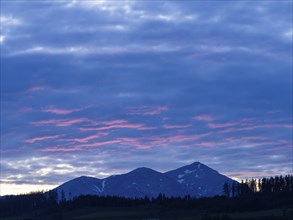 Sunset over mountain peak, Eisenerz Alps, Goesseck, view from the lowland, Leoben, Styria, Austria,