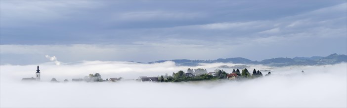 Church rises out of the morning mist, Frauenberg pilgrimage church, panoramic view, near Leibnitz,