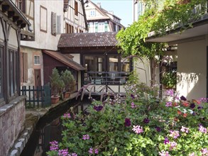 Historic half-timbered houses with floral decorations in Alsace, Wissembourg, France, Europe