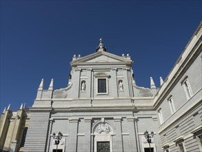 The picture shows the facade of a historic church under a clear blue sky, Madrid, Spain, Europe