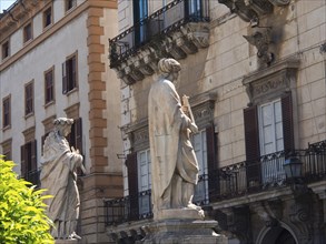 Historic buildings with balustrades and sculptures in the city, palermo in sicily with an