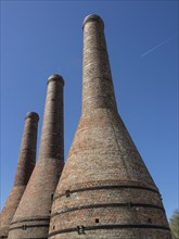 Close-up of three tall brick chimneys against a clear sky, Enkhuizen, Nirderlande