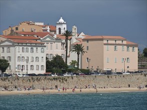 Coastal town with pastel-coloured buildings and beach area, sea view, Corsica, ajaccio, France,