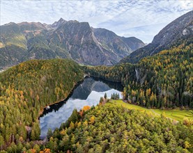 Aerial view, mountain peaks of the Oetztal Alps reflected in Lake Piburger See, in autumn, near