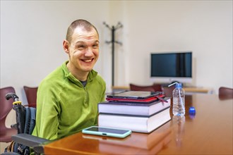Man with disability sitting in wheelchair in the study room of the university