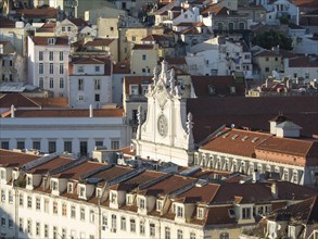 Aerial view of red roofs and white buildings in an old town with historical details, Lisbon,
