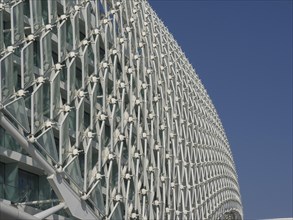 Detailed view of a complex glass structure of a modern building under a clear sky, Abu Dhabi, Arab