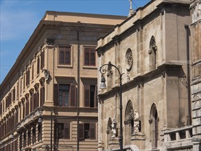 Historic buildings with ornate facades and windows under a blue sky, palermo in sicily with an
