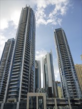 Modern skyscrapers with glass facades against a bright sky in Dubai, dubai, arab emirates