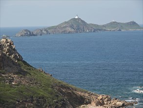 Coastal landscape with islands and lighthouses, surrounded by water and rocky cliffs, Corsica,