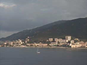 Coastal town with numerous residential buildings on a wooded hillside, Corsica, ajaccio, France,