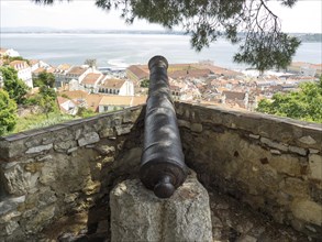 Historic cannon on a viewpoint overlooking a city and the water, Lisbon, Portugal, Europe