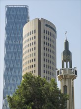 Modern skyscrapers and minaret in Abu Dhabi, sky and trees in the background, Abu Dhabi, United