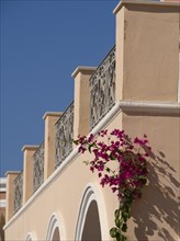 Bougainvillea on a Mediterranean style building with balcony and blue sky, The volcanic island of