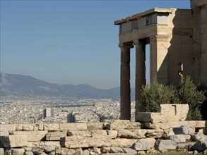 An ancient temple with a view of the modern city and surrounding mountains, Ancient buildings with