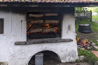 Pork roll roast on a spit cooked in an old oven, Allgaeu, Bavaria, Germany, Europe