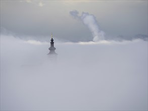 Church tower rises out of the morning mist, Frauenberg pilgrimage church, near Leibnitz, Styria,