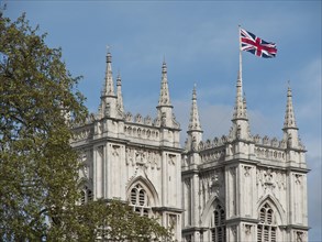 Historic building with British flag under a blue sky, London, England, United Kingdom, Europe