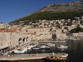 City at the harbour with many boats, surrounded by hills and blue sea, the old town of Dubrovnik