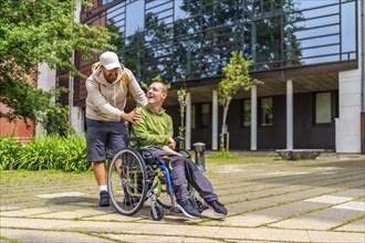 Full length photo of a caucasian adult man with special needs and friend walking along the