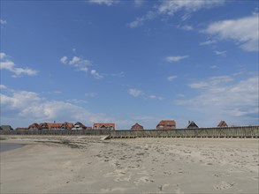 Coastal landscape with a wide beach and traditional houses, Baltrum Germany