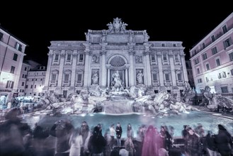 Trevi Fountain at Night with Crowd of People in Motion in Rome, Lazio, Italy, Europe
