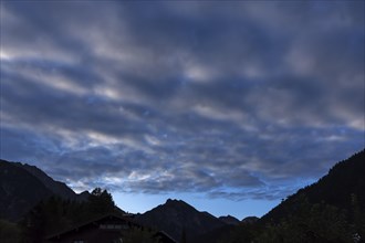 Cluster layer clouds (stratocumuli) with silhouette of the Allgaeu mountains, Hinterstein, Bad