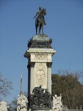A monument with an equestrian statue at the top, surrounded by classical statues and ornaments