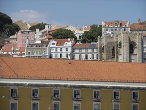 View over the rooftops and old buildings of a historic city spread over hilly terrain, Lisbon,