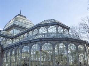 Large glass greenhouse with metallic frame that captures sunlight and houses plants, Madrid, Spain,