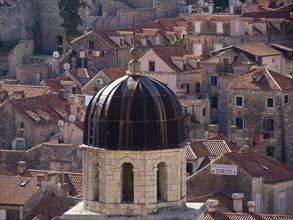 Domed roof of a church and surrounding old buildings with red roof tiles, the old town of Dubrovnik