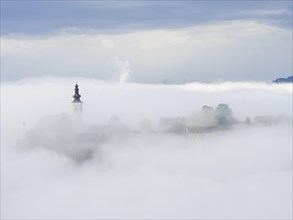 Church tower rises out of the morning mist, Frauenberg pilgrimage church, near Leibnitz, Styria,