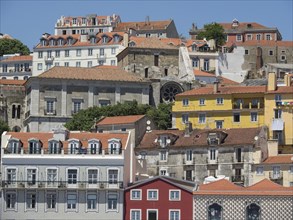 Various colourful houses and buildings in Lisbon lined up along a hill, Lisbon, Portugal, Europe