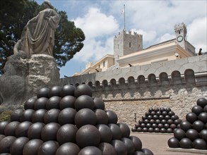 A historic fortress with statues and cannonballs in front of a building, Monte Carlo, Monaco,