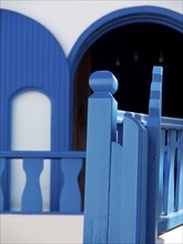 Balcony railings and windows of a house in intense shades of blue, The volcanic island of Santorini
