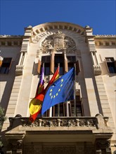 Facade of a building with european flag and national flag, palma de mallorca on the mediterranean