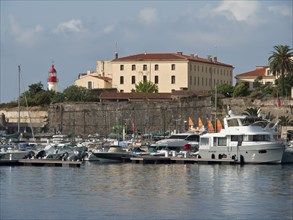 Historic buildings and lighthouse at the harbour with many yachts and boats, Corsica, ajaccio,
