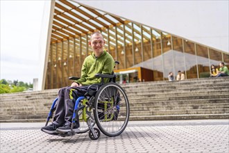 Full length low angle view portrait of a happy caucasian adult man with cerebral palsy smiling