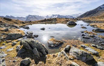 Small lake on the high plateau of the Gurgler Seenplatte, glaciated mountain peaks in the
