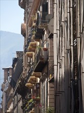 View of narrow streets with balconies and historic buildings in a mediterranean old town, palermo