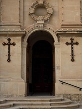 Entrance of a church with two large crosses and decorated archway, Valetta, Malta, Europe