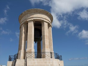 A classic turret rises under a bright, cloudy sky, Valetta, Malta, Europe