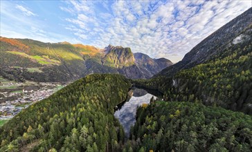 Aerial view, mountain peaks of the Oetztal Alps reflected in Lake Piburger See, in autumn, near