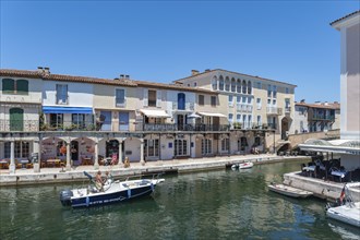 Townscape with restaurants and shops at the Pont principal du port grimaud, Port Grimaud, Var,