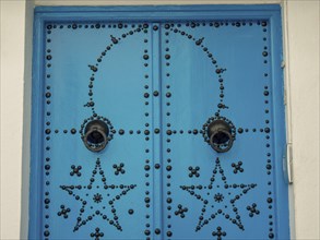 Traditionally decorated blue door on a white building, Mediterranean architecture, Tunis in Africa