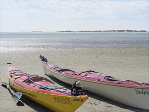 Two kayaks lying on the beach, ready for a water adventure, Baltrum Germany